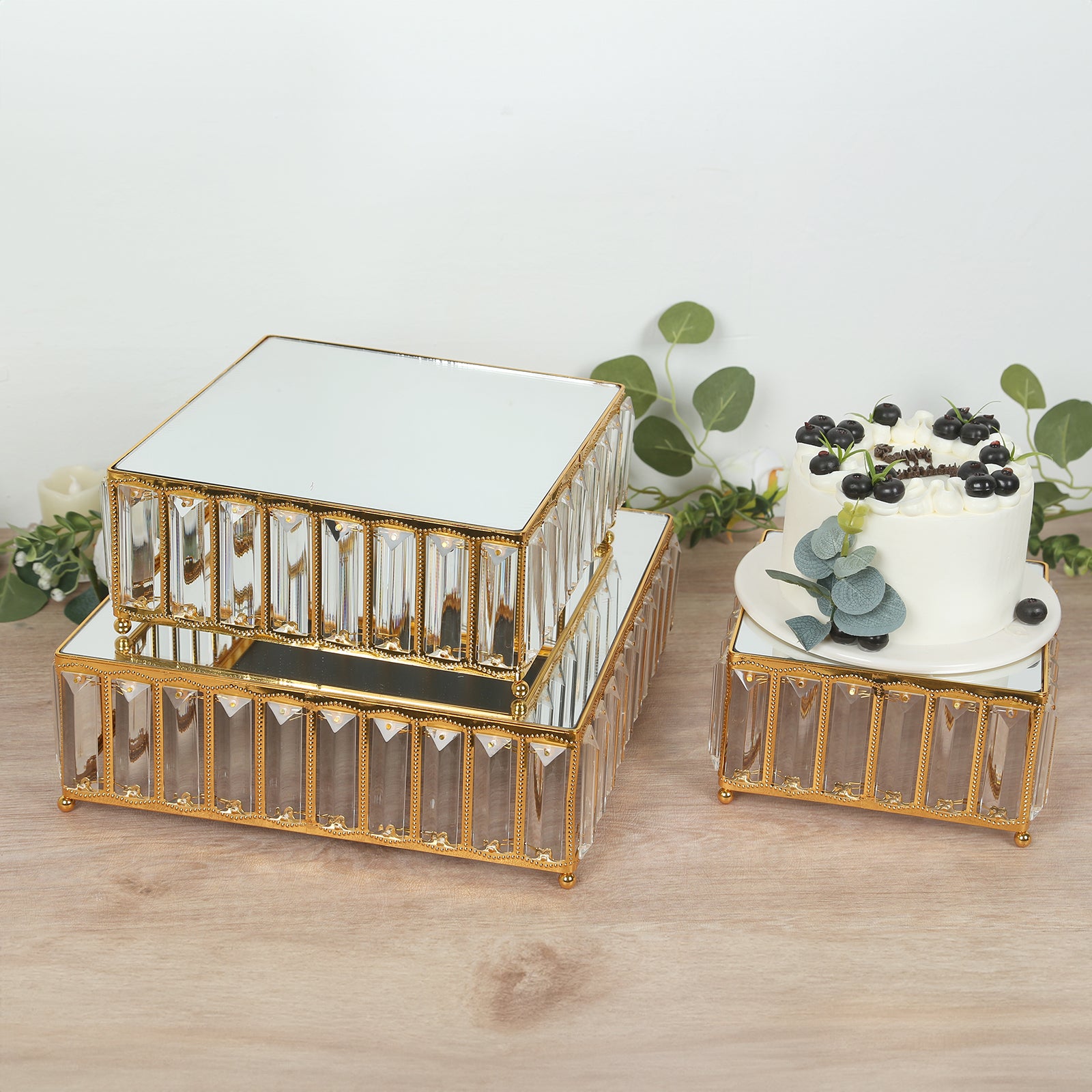Gold metal crystal pendant cake stands with mirror tops, stackable dessert trays.