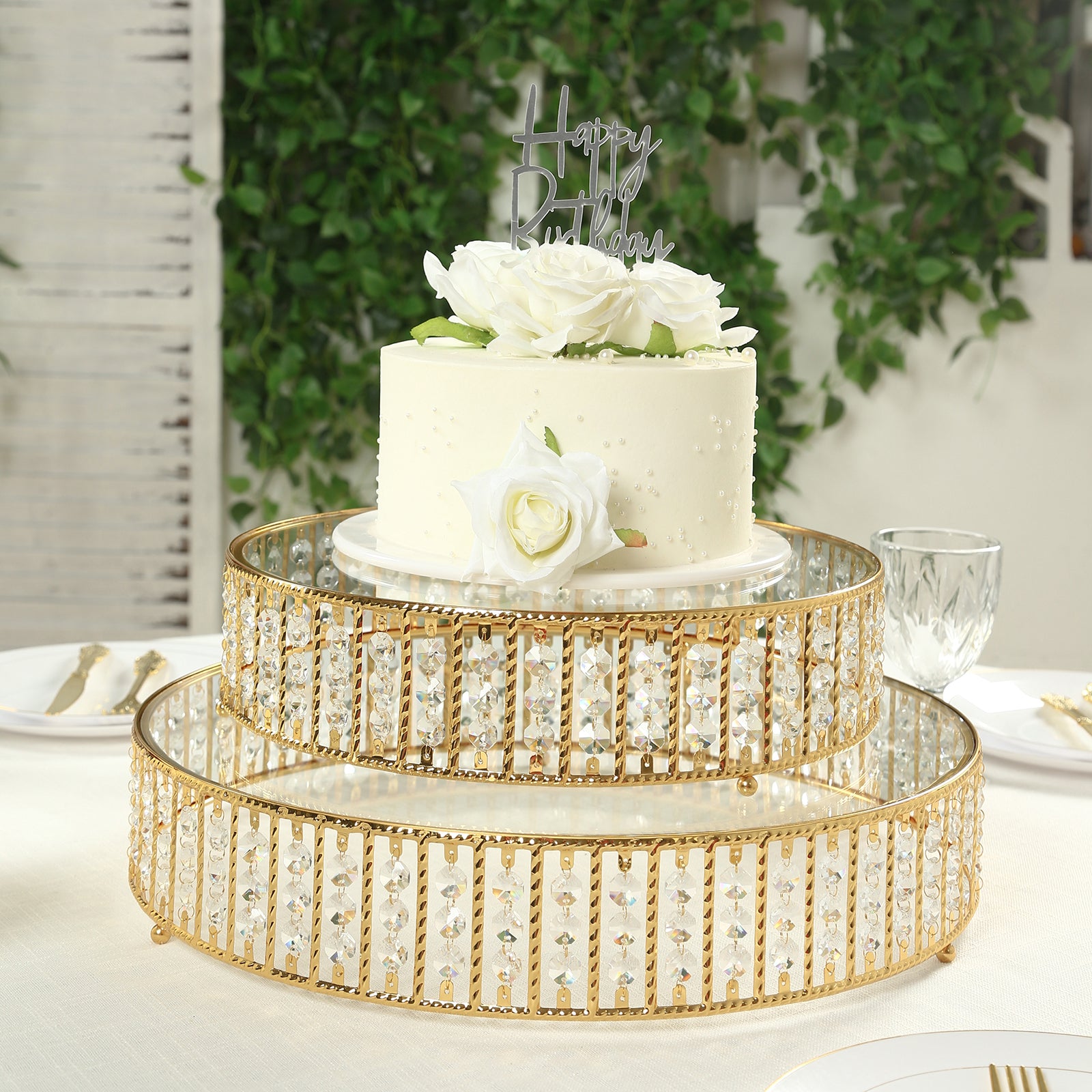 Gold round cake stand with hanging crystal beads and glass top.