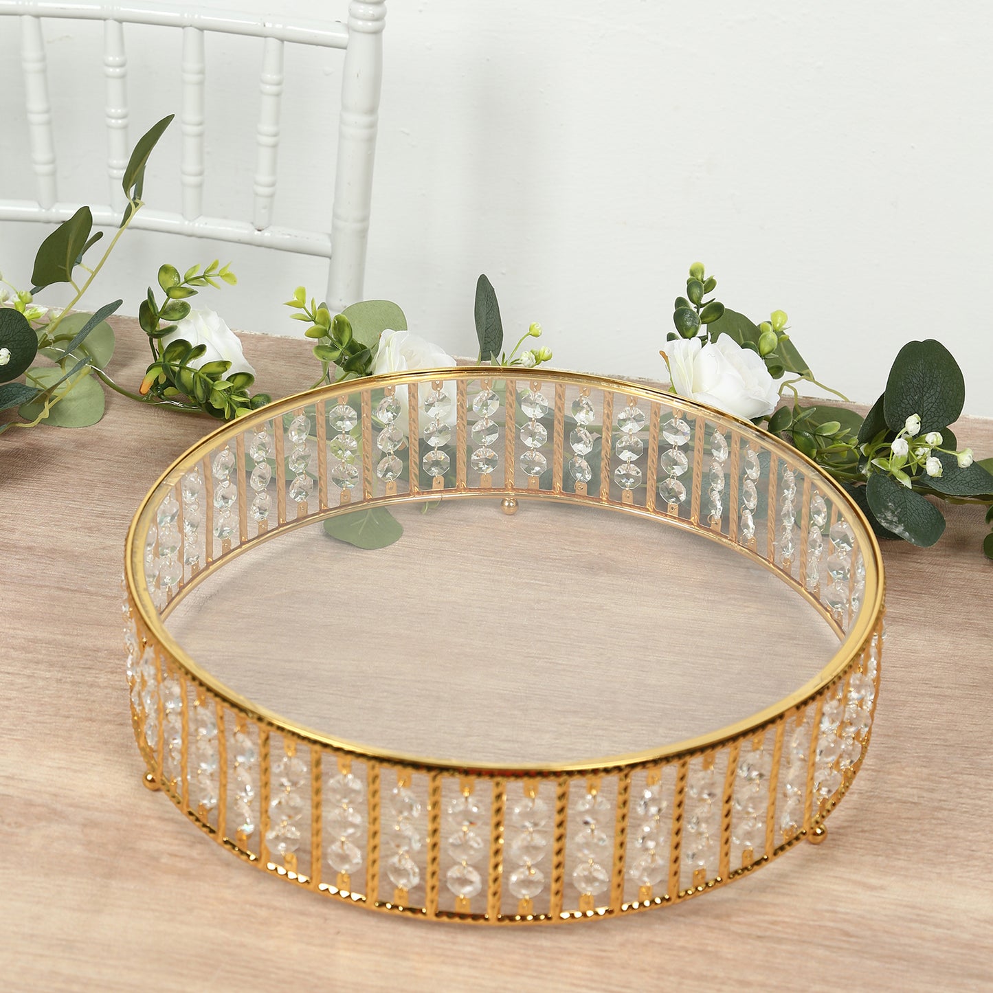 Gold round cake stand with hanging crystal beads and glass top.