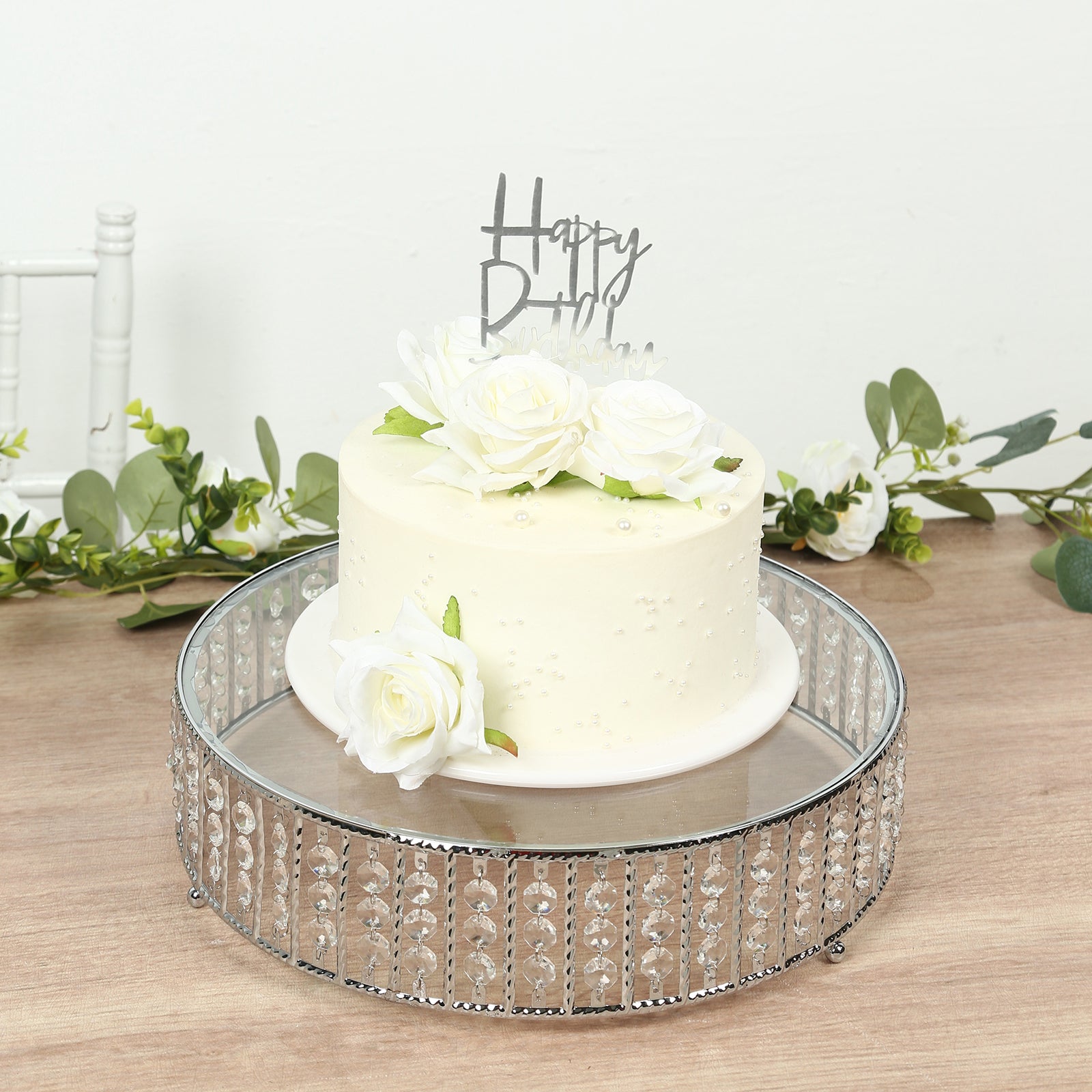 Silver round cake stand with hanging crystal beads and glass top.