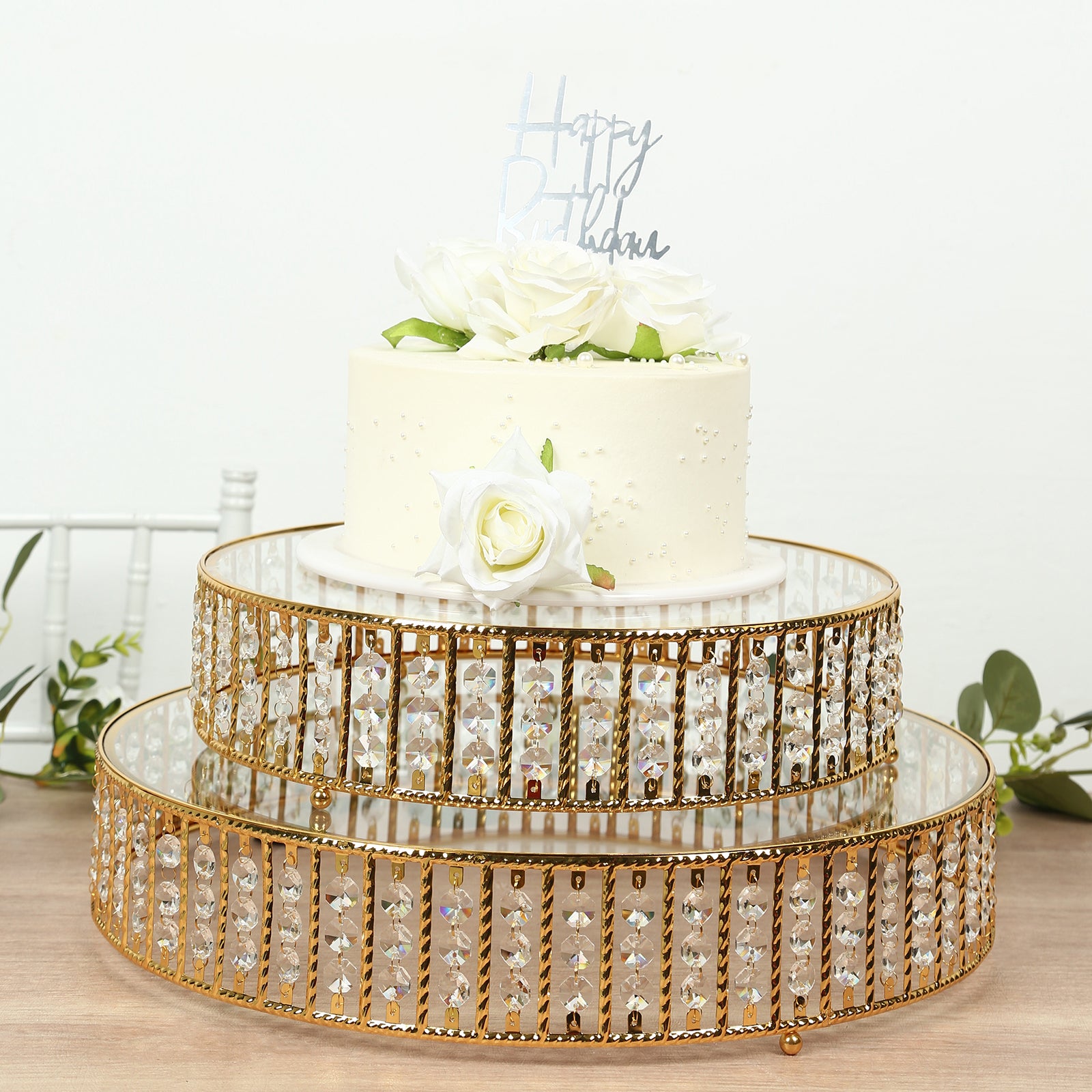 Gold round cake stand with hanging crystal beads and glass top, perfect for dessert display.