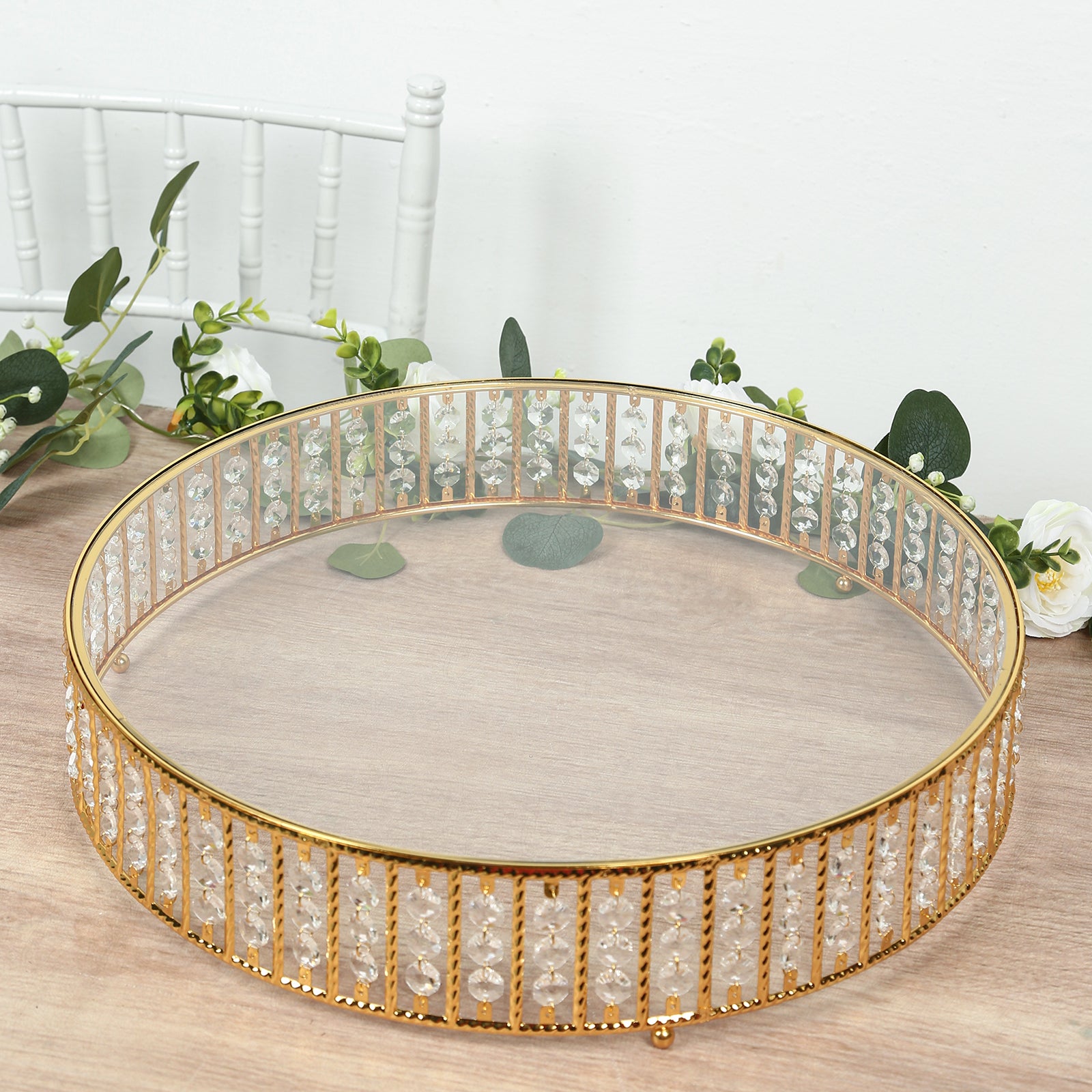 Gold cake stand with hanging crystal beads and glass top.