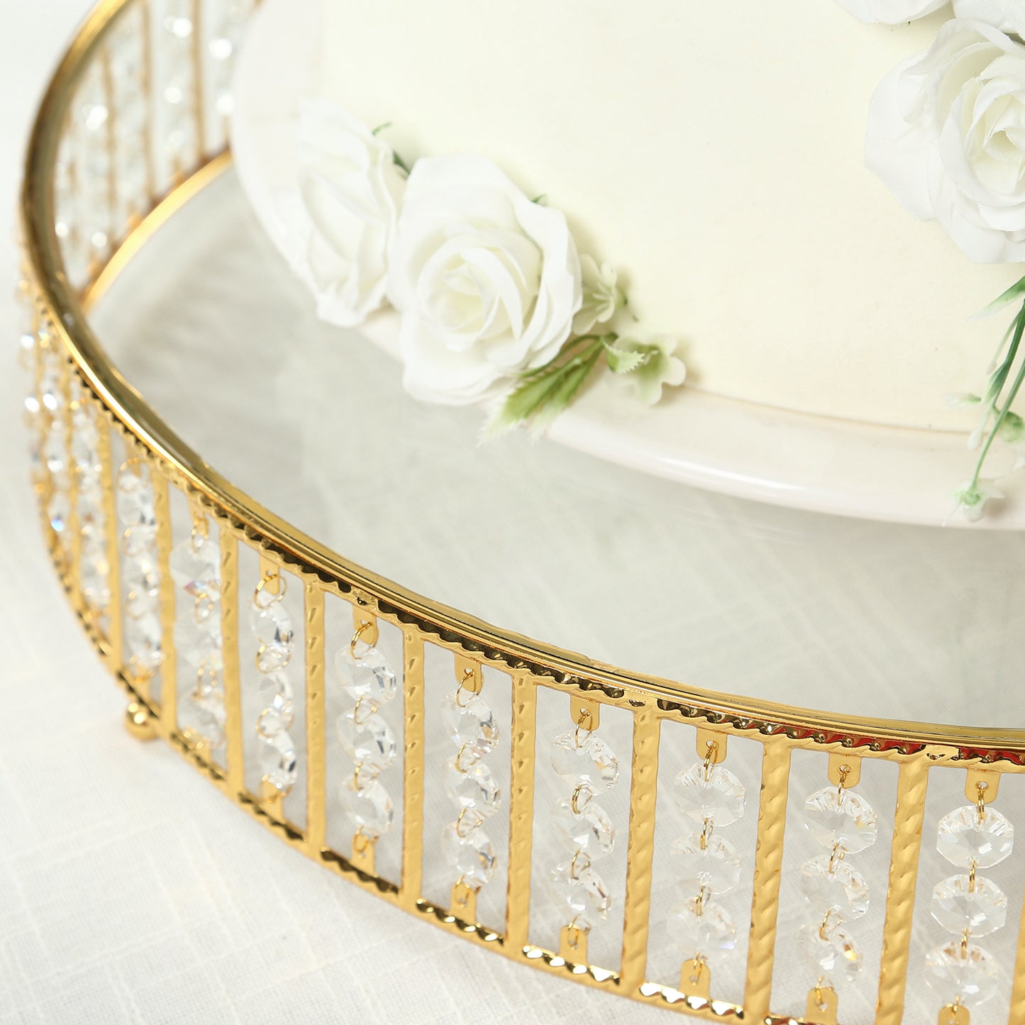 Gold cake stand with hanging crystal beads and glass top.