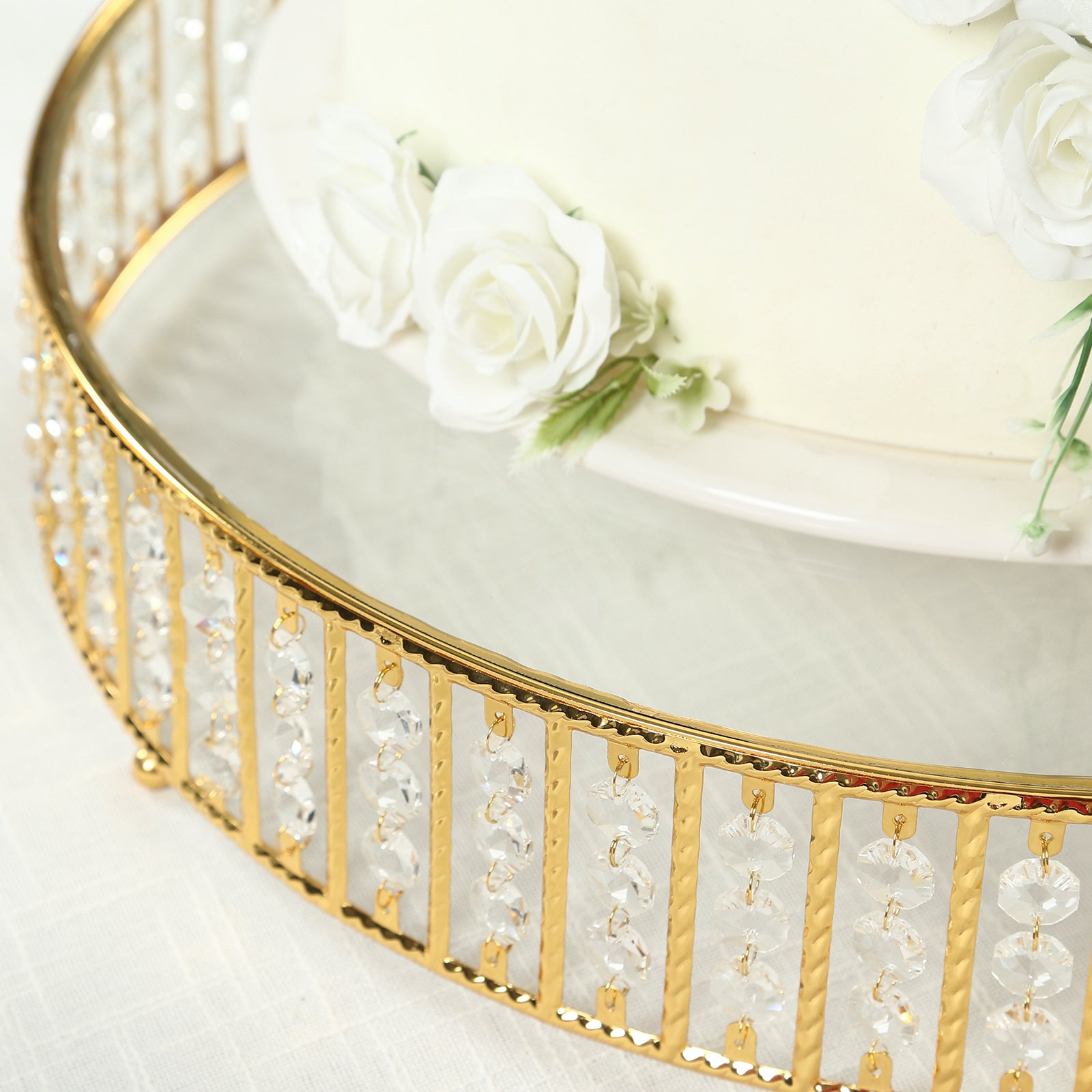Gold cake stand with hanging crystal beads and glass top.