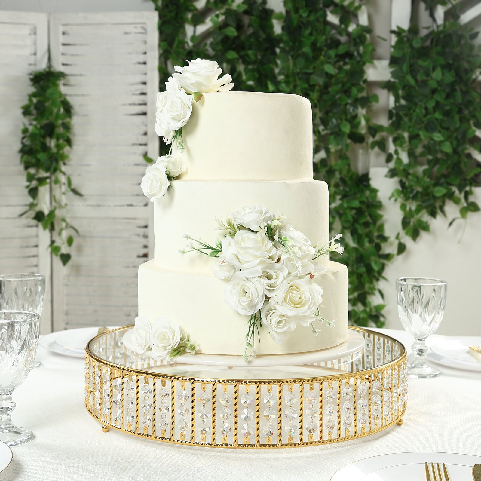 Gold round cake stand with hanging crystal beads and glass top.