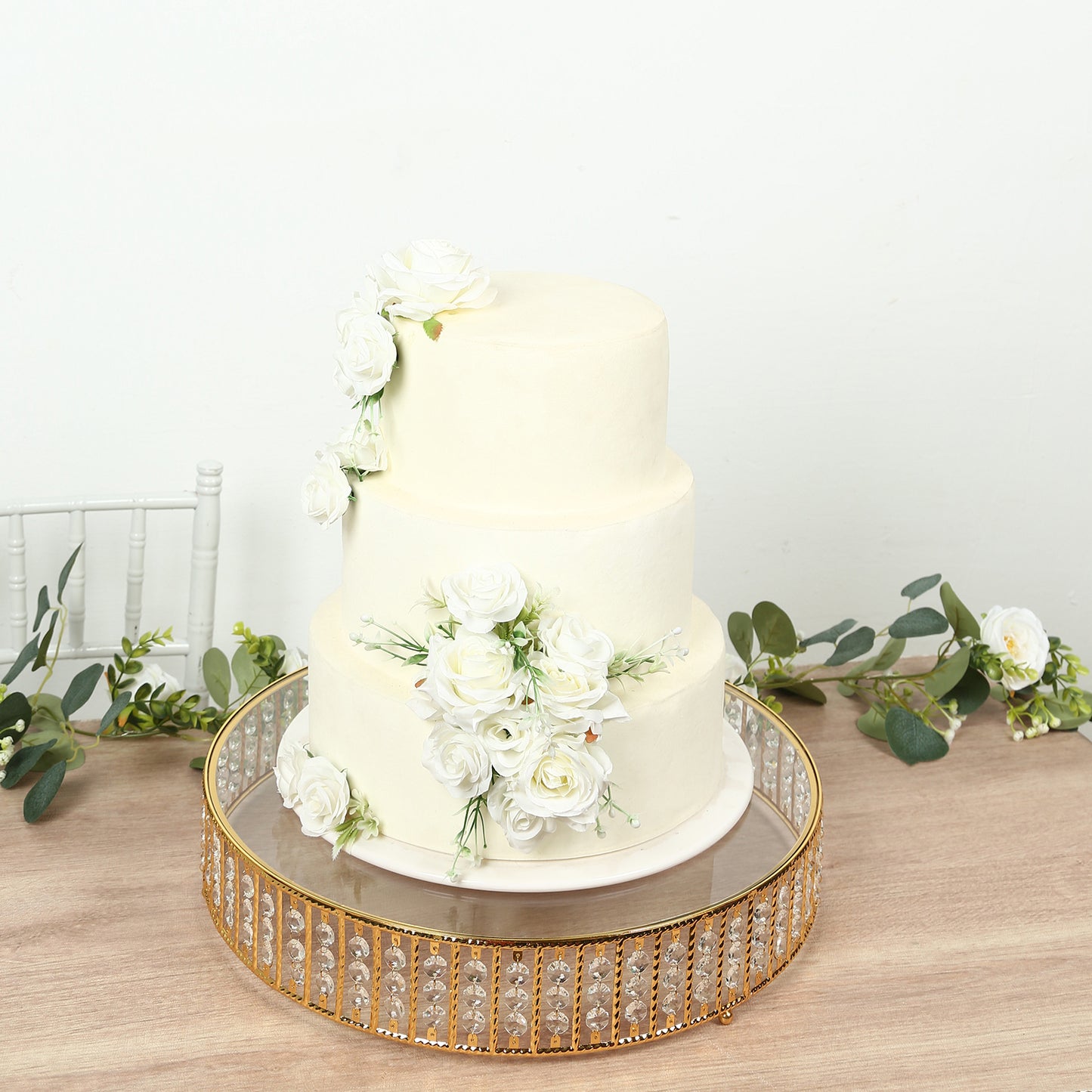 Gold round cake stand with crystal beads and glass top, perfect for desserts.