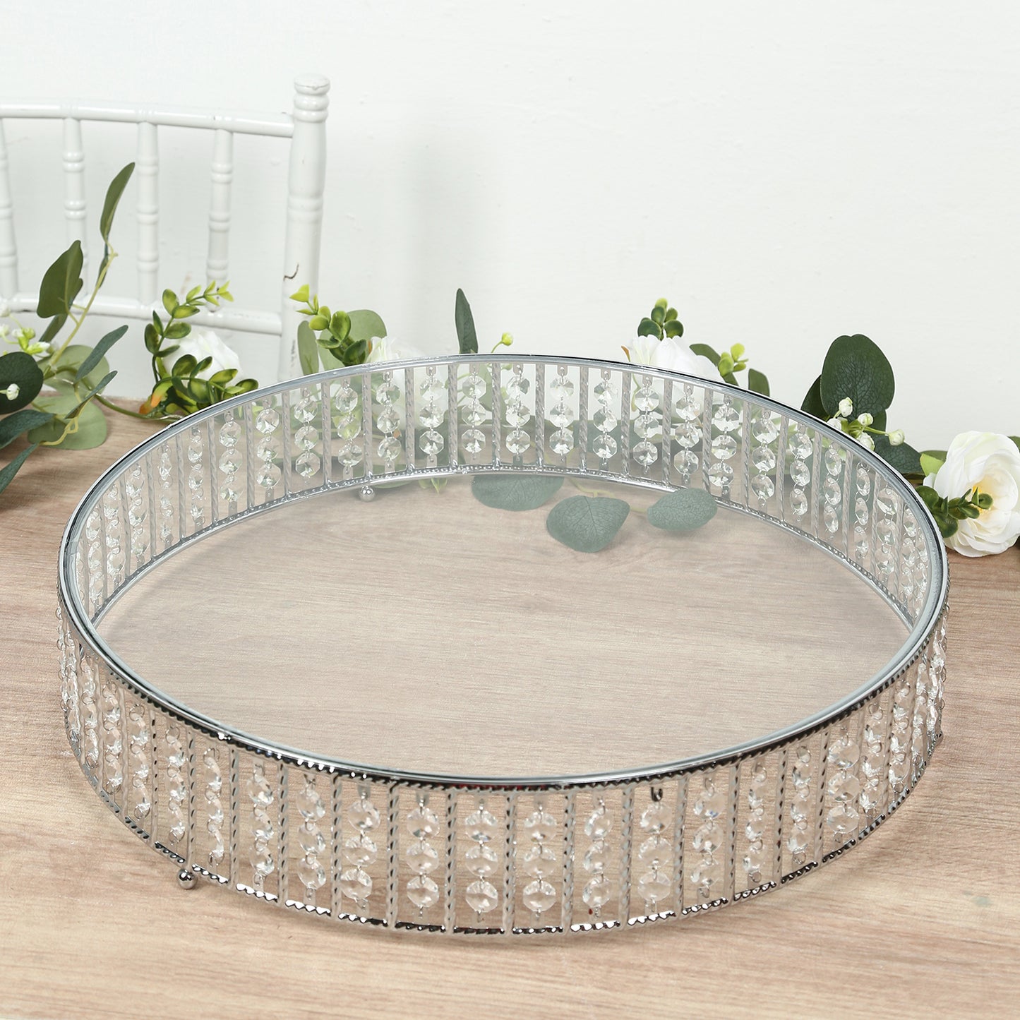 Silver round cake stand with hanging crystal beads and glass top.