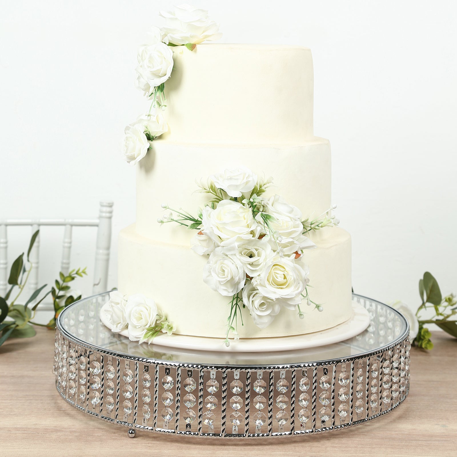 Silver round cake stand with hanging crystal beads, perfect for elegant desserts.