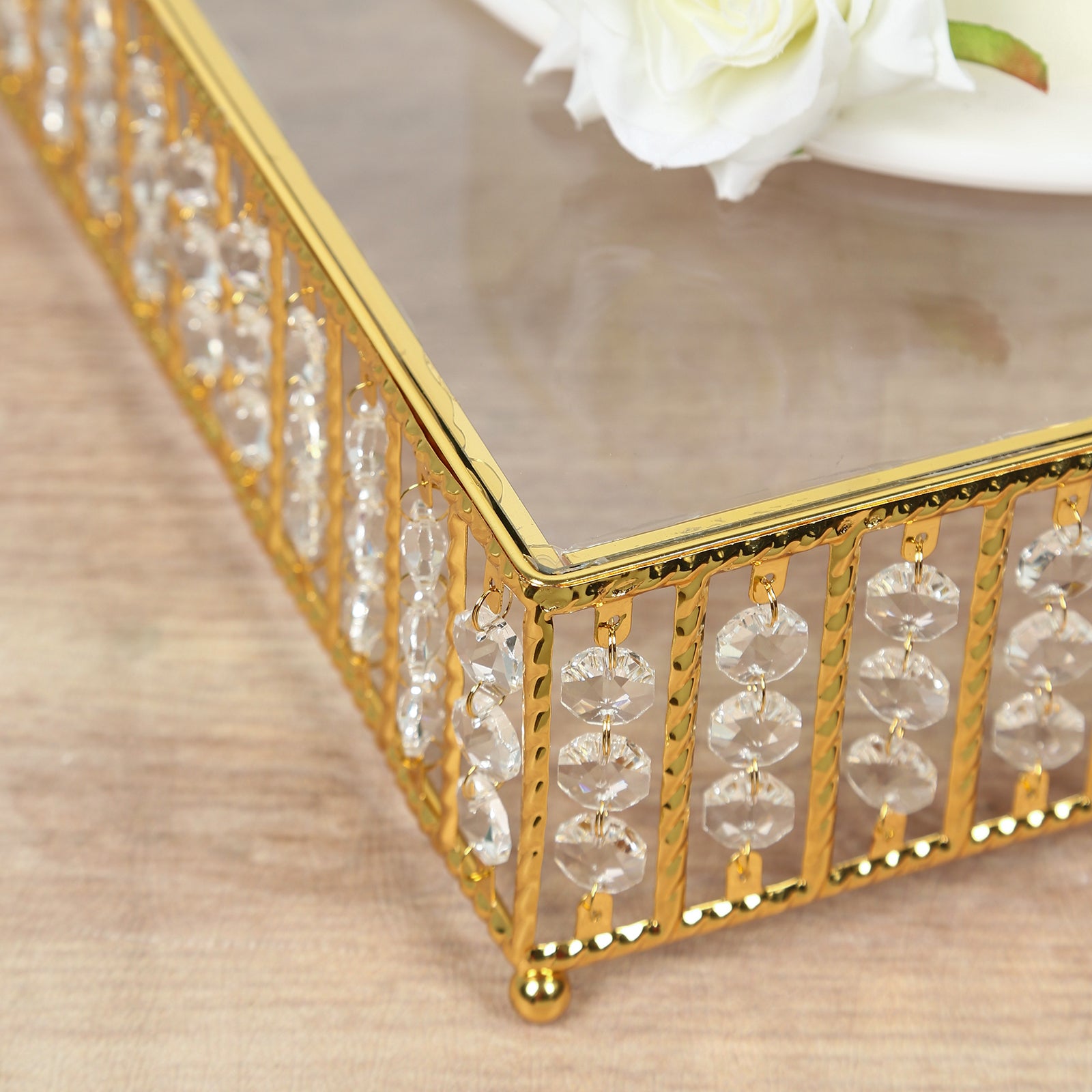 Gold cake stand with hanging crystal beads and glass top.