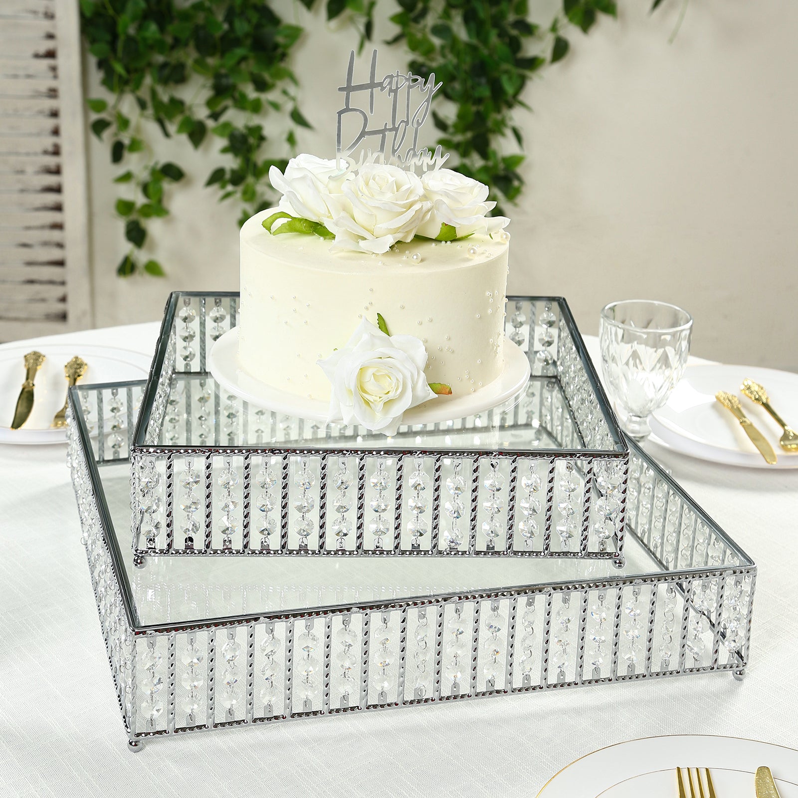 Silver cake stand with hanging crystal beads and glass top, perfect for dessert display.