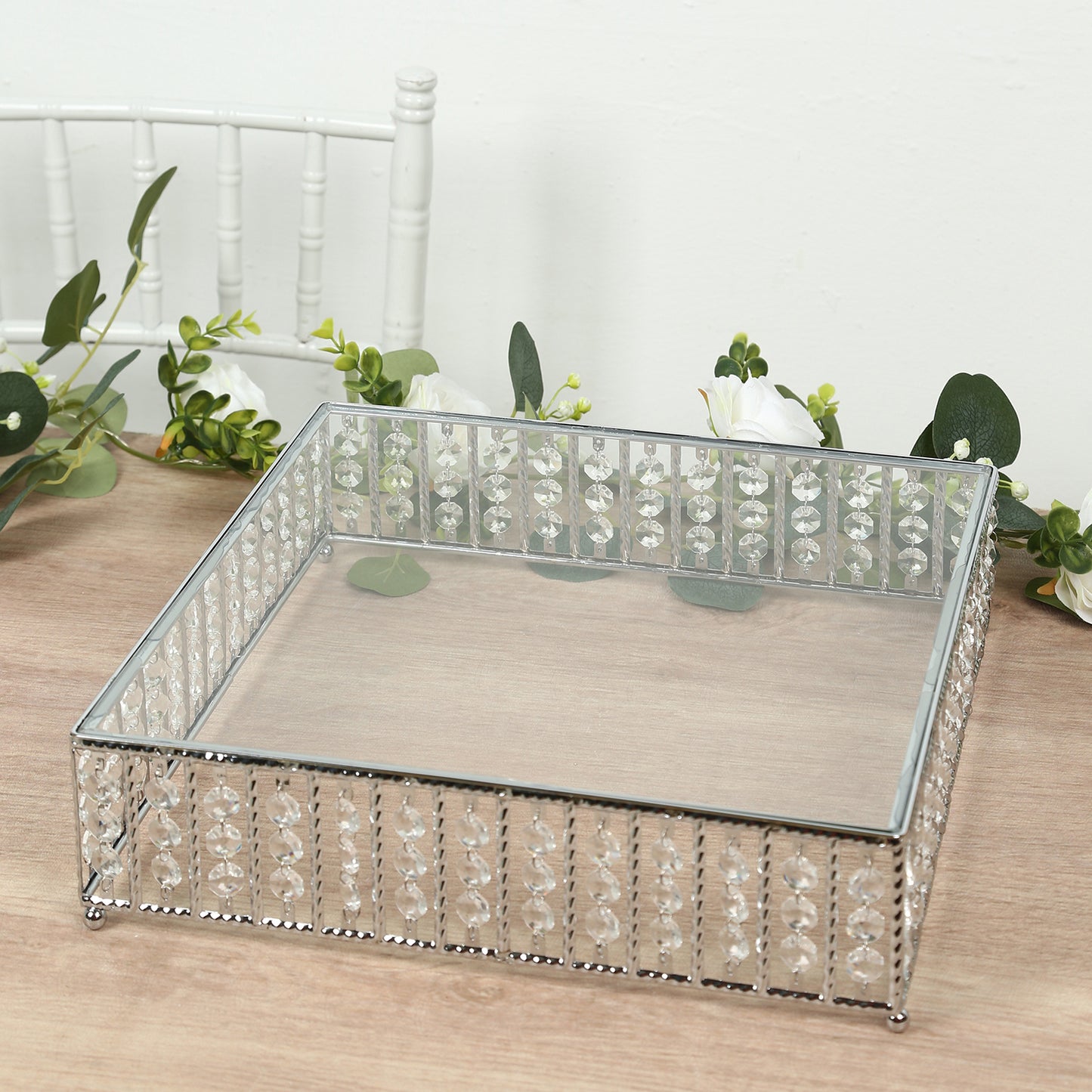 Silver square cake stand with hanging crystal beads and glass top.