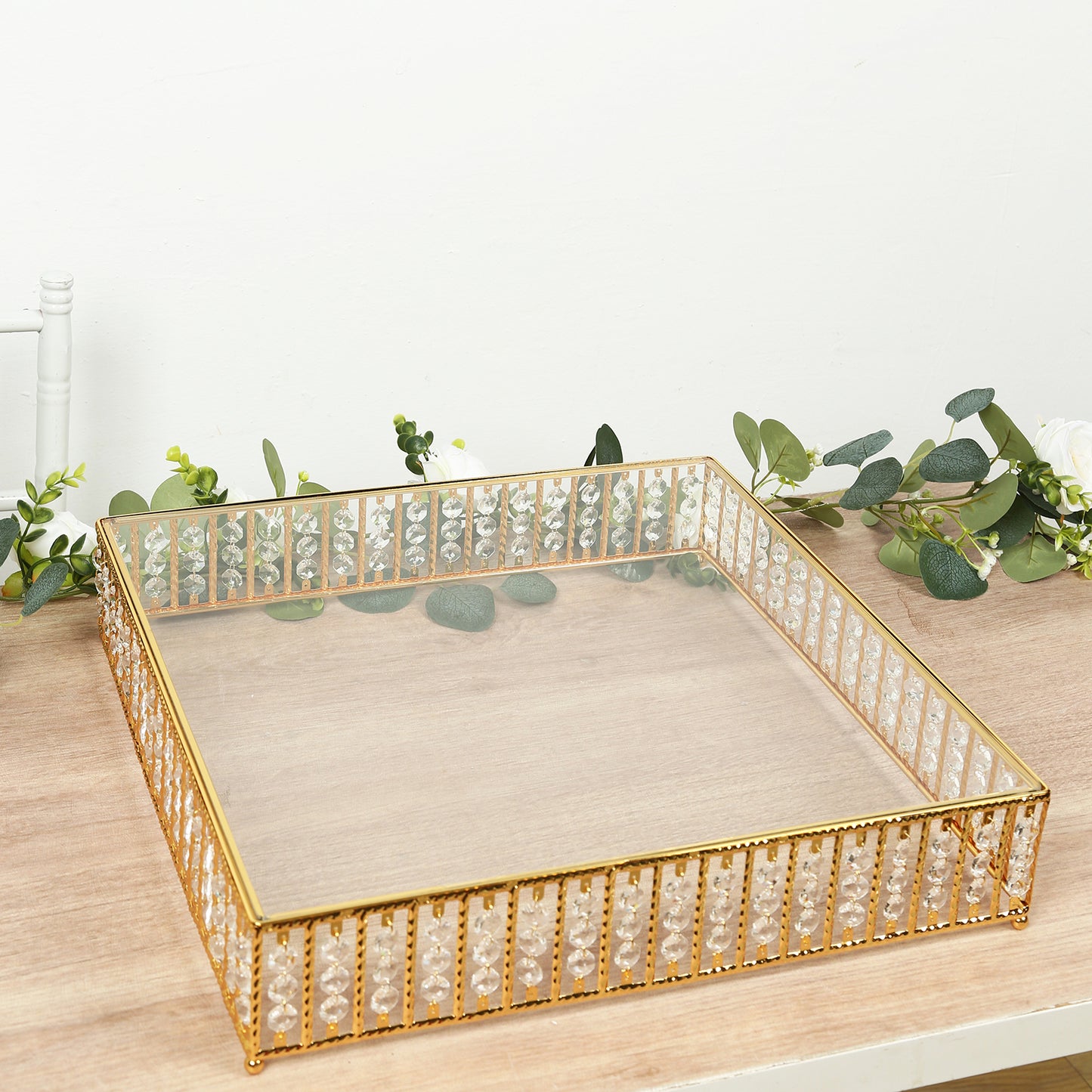 Gold square cake stand with hanging crystal beads and glass top.