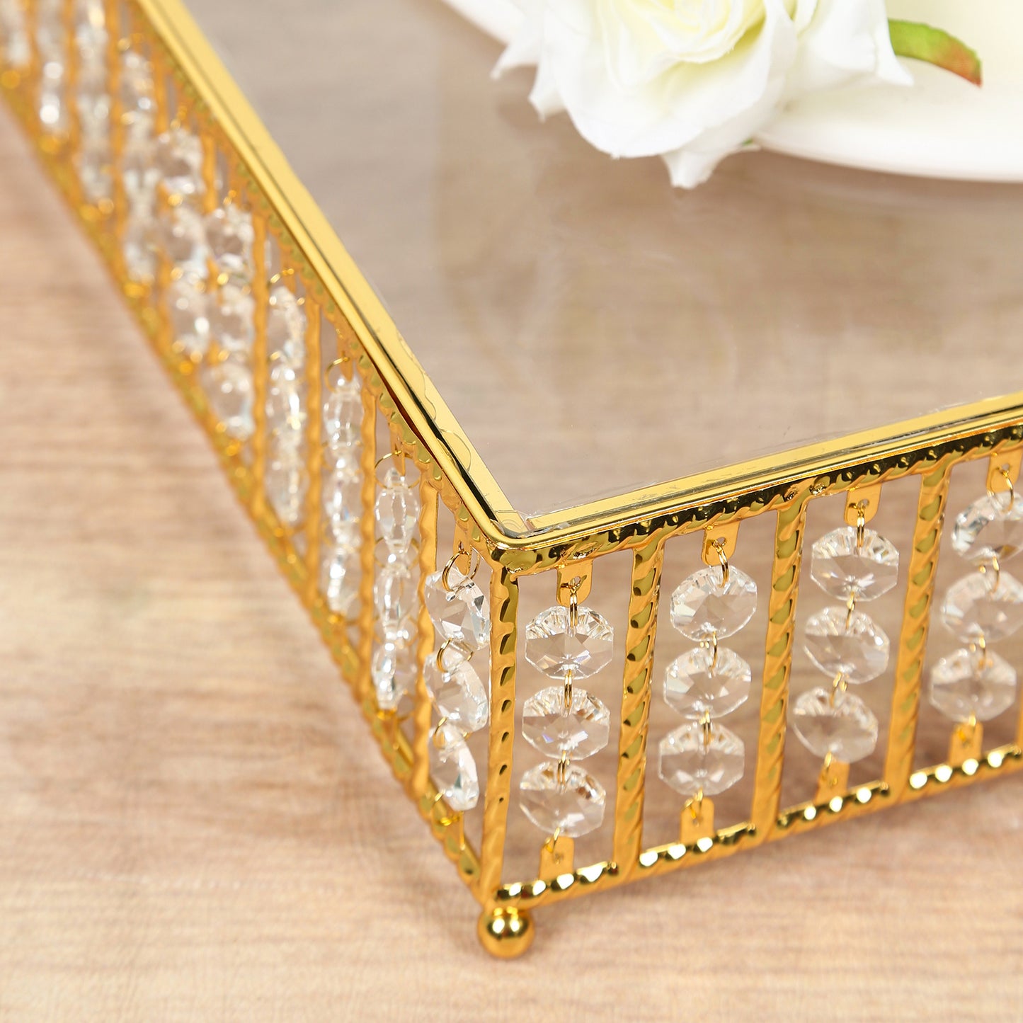 Gold cake stand with hanging crystal beads and glass top.