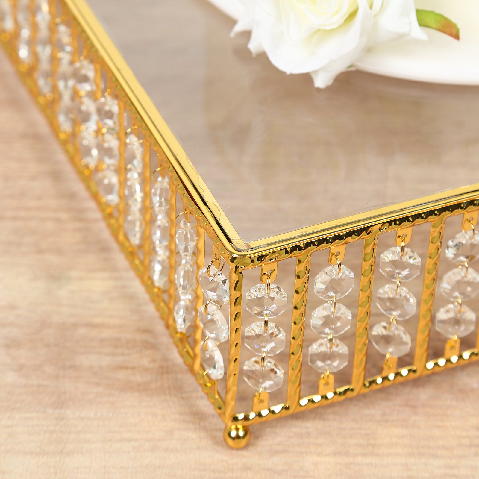 Gold cake stand with hanging crystal beads and glass top.