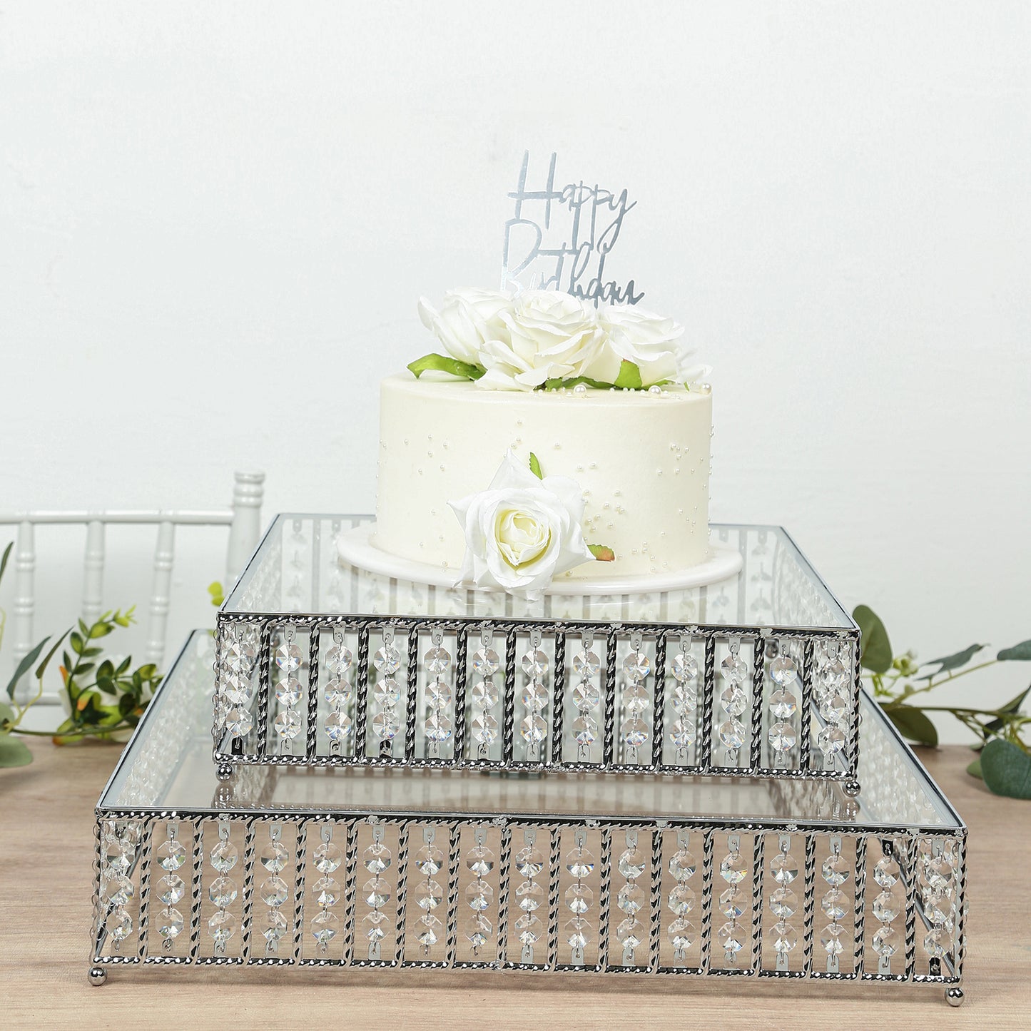 Silver cake stand with hanging crystal beads and glass top, perfect for desserts.