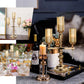 Gold candelabra with amber glass shades for elegant candle display.