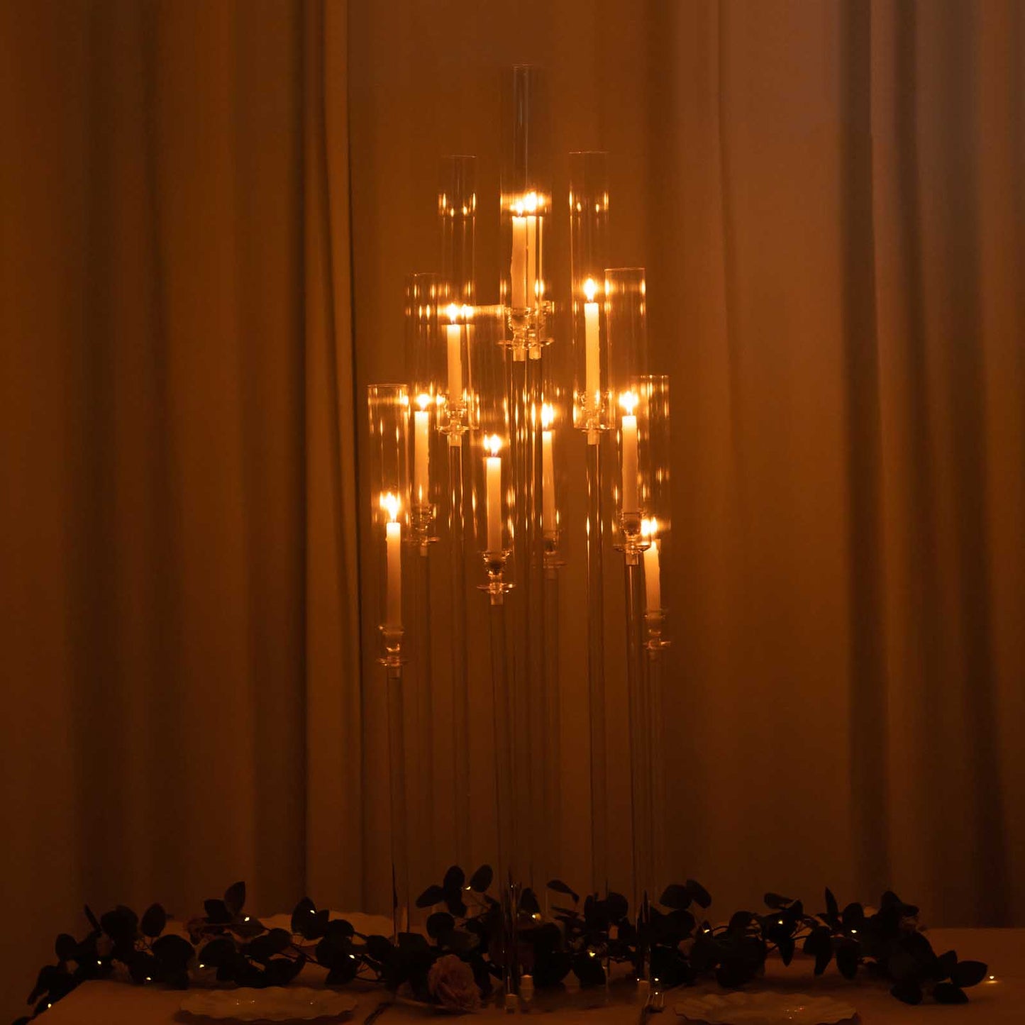 Clear acrylic candelabra with 10 arms holding taper candles, 47" tall.