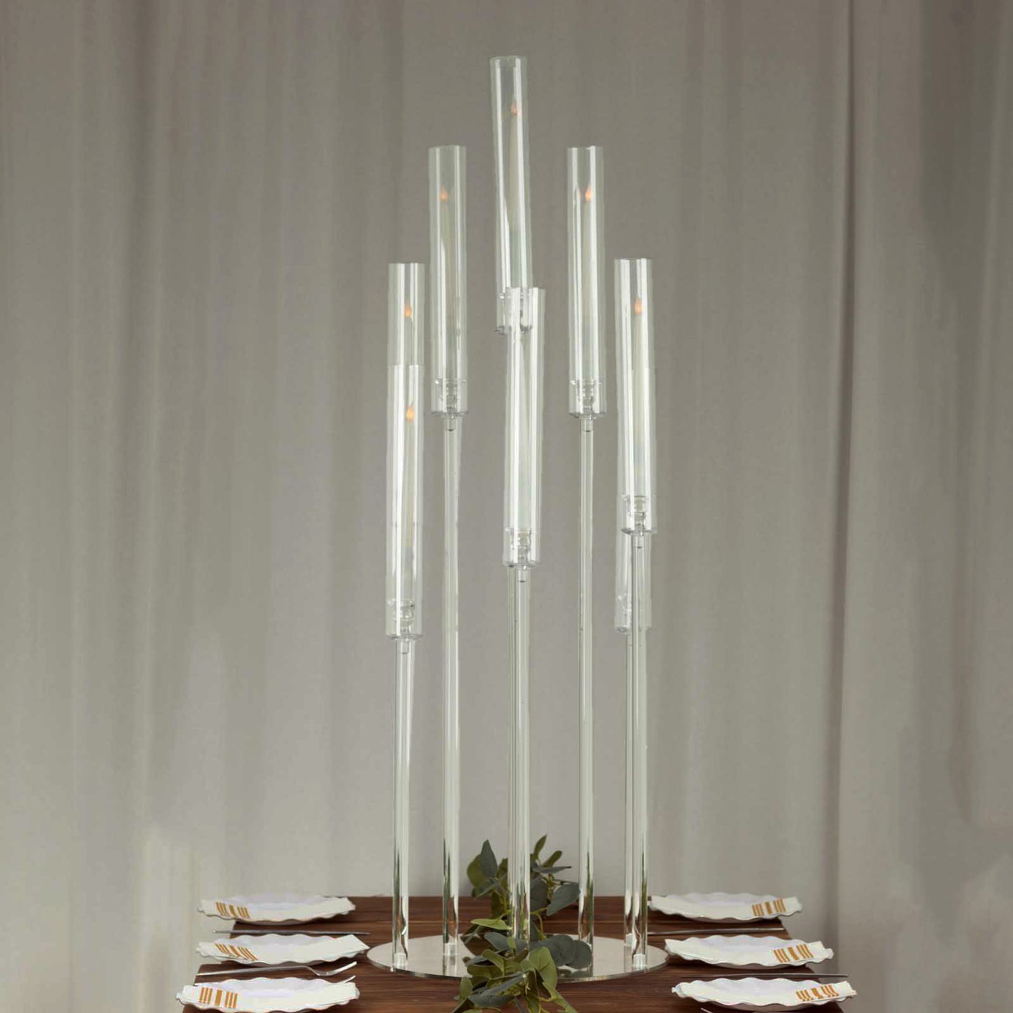 Clear acrylic candelabra candle holder, 47" tall with circular base.