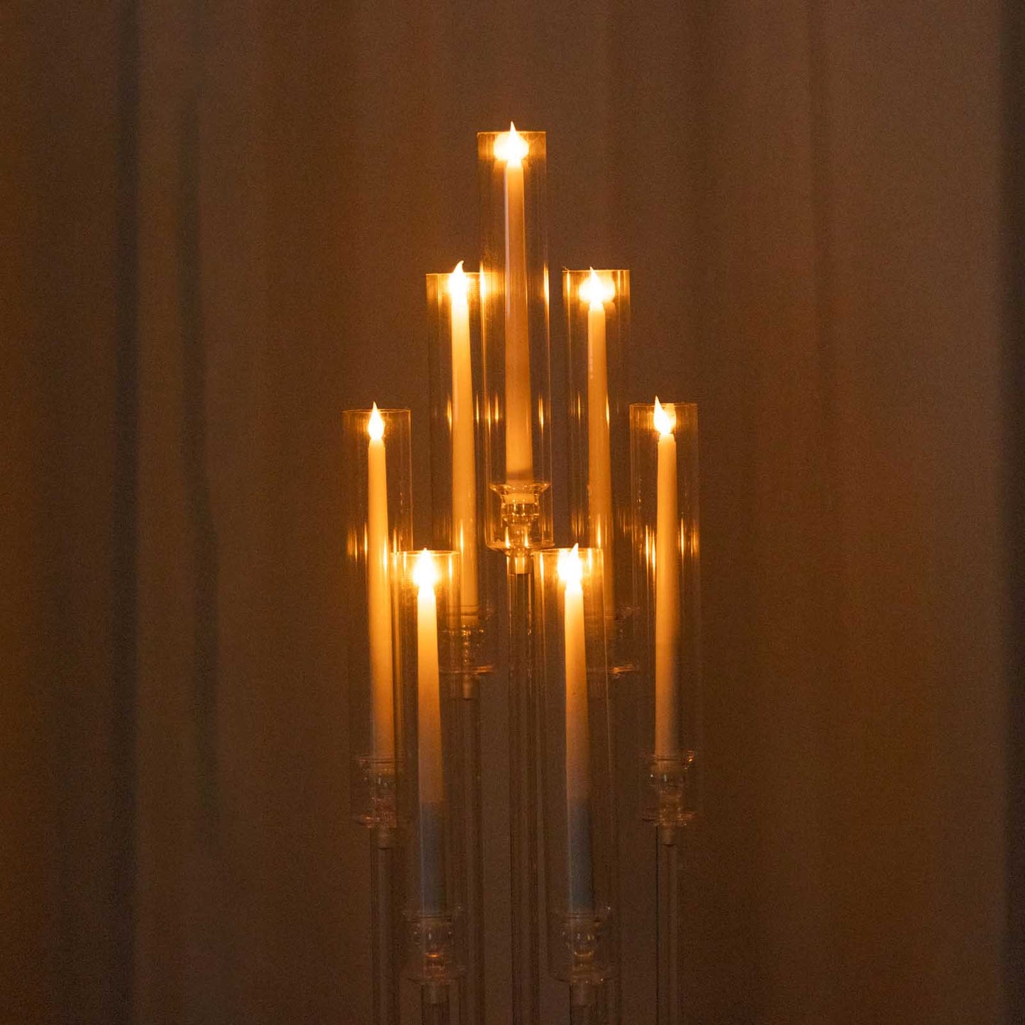 Clear acrylic candelabra with 7 arms and taper candles, 33" tall.