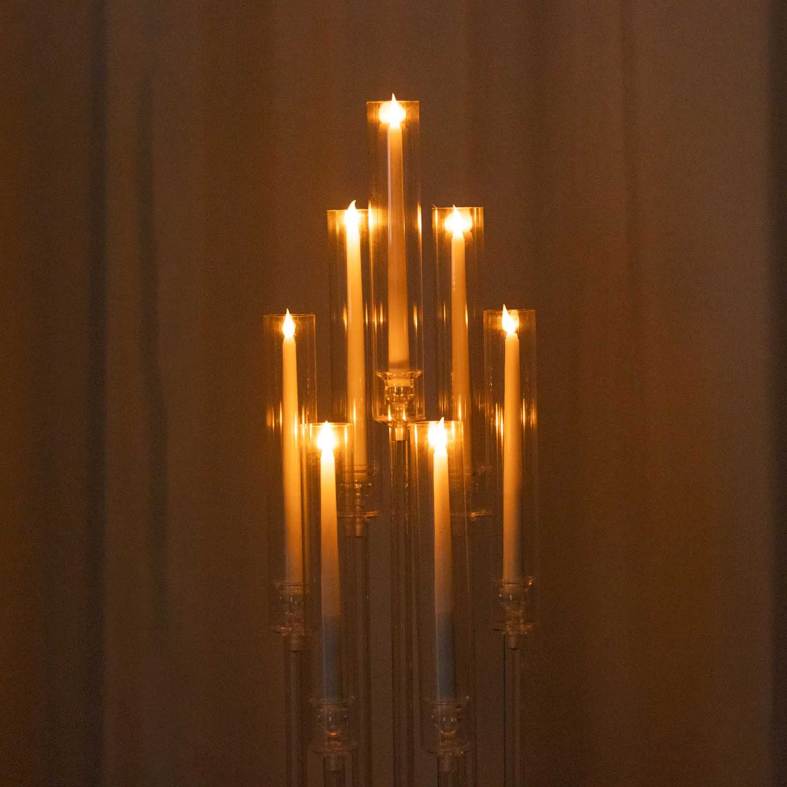 Clear acrylic candelabra with 7 arms and taper candles, 33" tall.