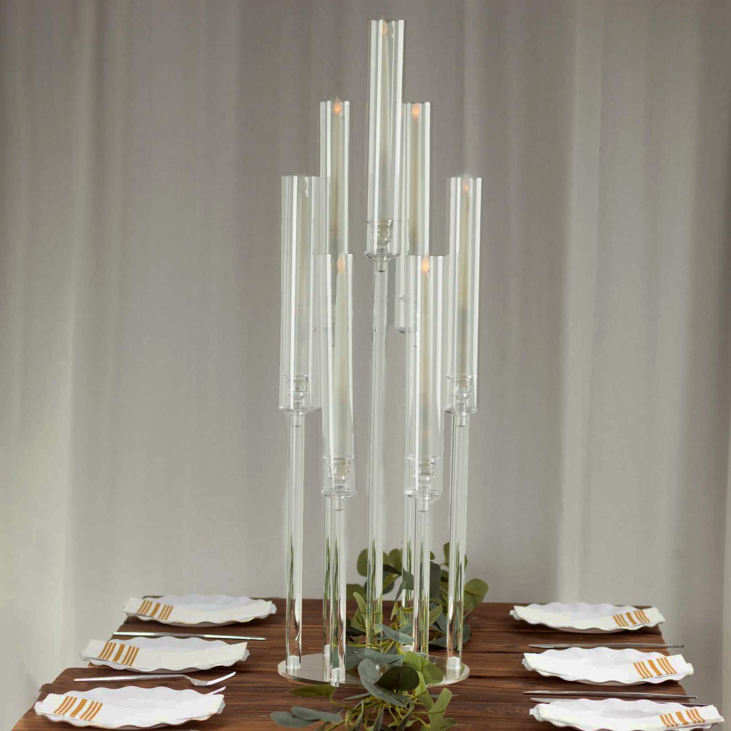 Clear acrylic 7-arm candelabra for taper candles, 33" tall with a circular base.