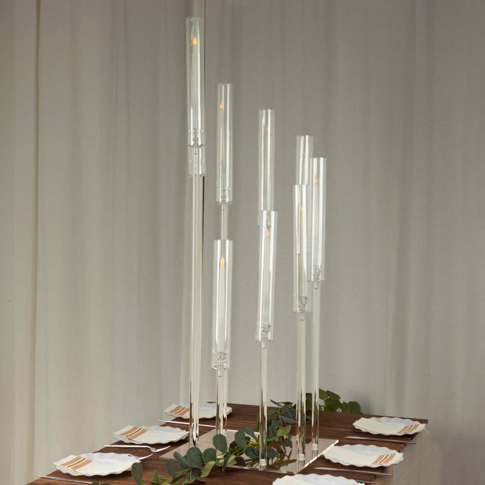Clear acrylic candelabra with 9 arms, 4ft tall, on a dining table.