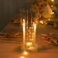 Clear glass candle shades with candles inside, illuminated softly.