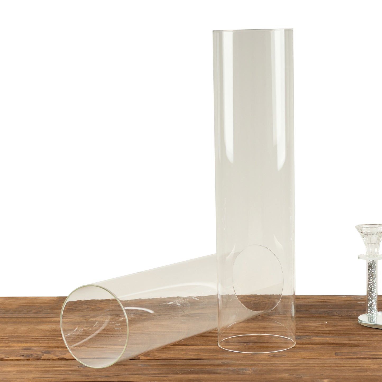 Clear glass candelabra candle holders with open ends, 20 inches tall.