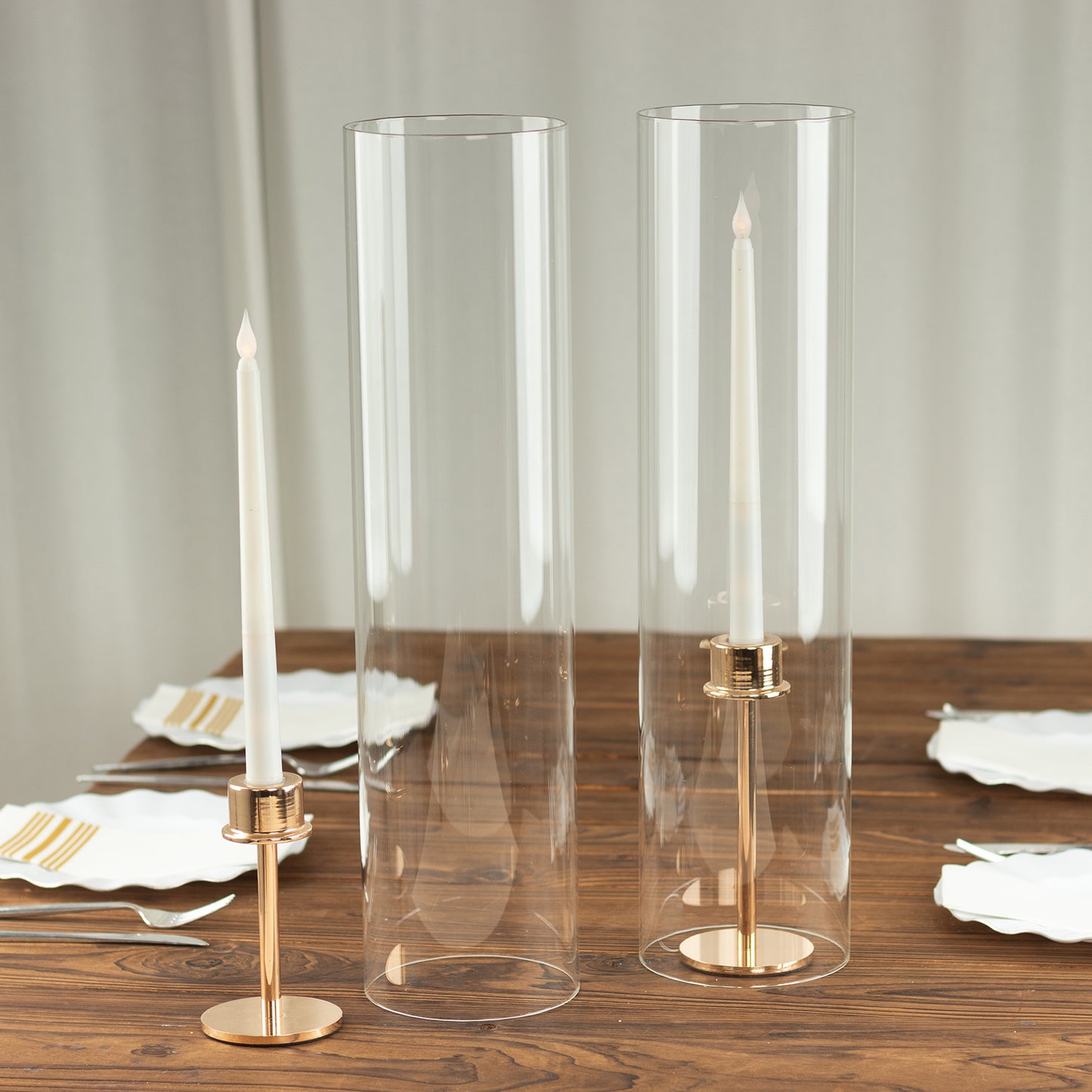 Clear glass candle holders with open ends for pillar candles. 20 inches tall.