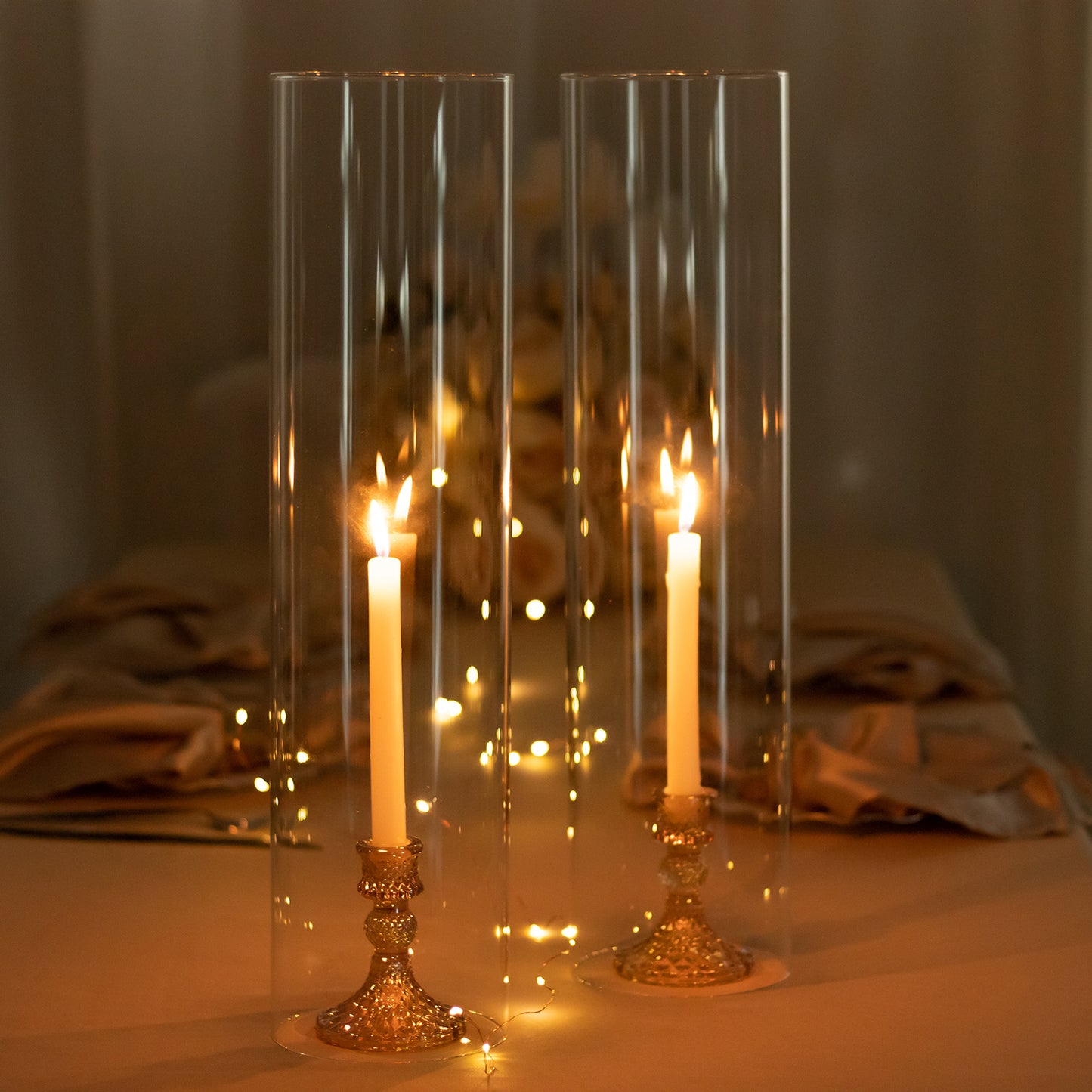 Clear candelabra candle holders with open ends and pillar candles.