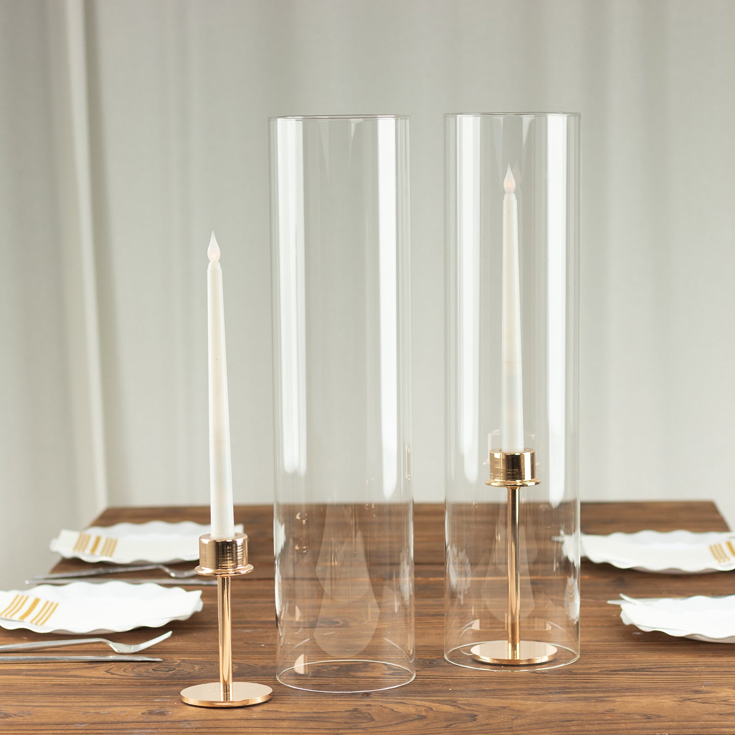 Clear candle holders with gold accents for pillar candles.