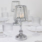 Silver crystal pendant candle holders on a table setting.