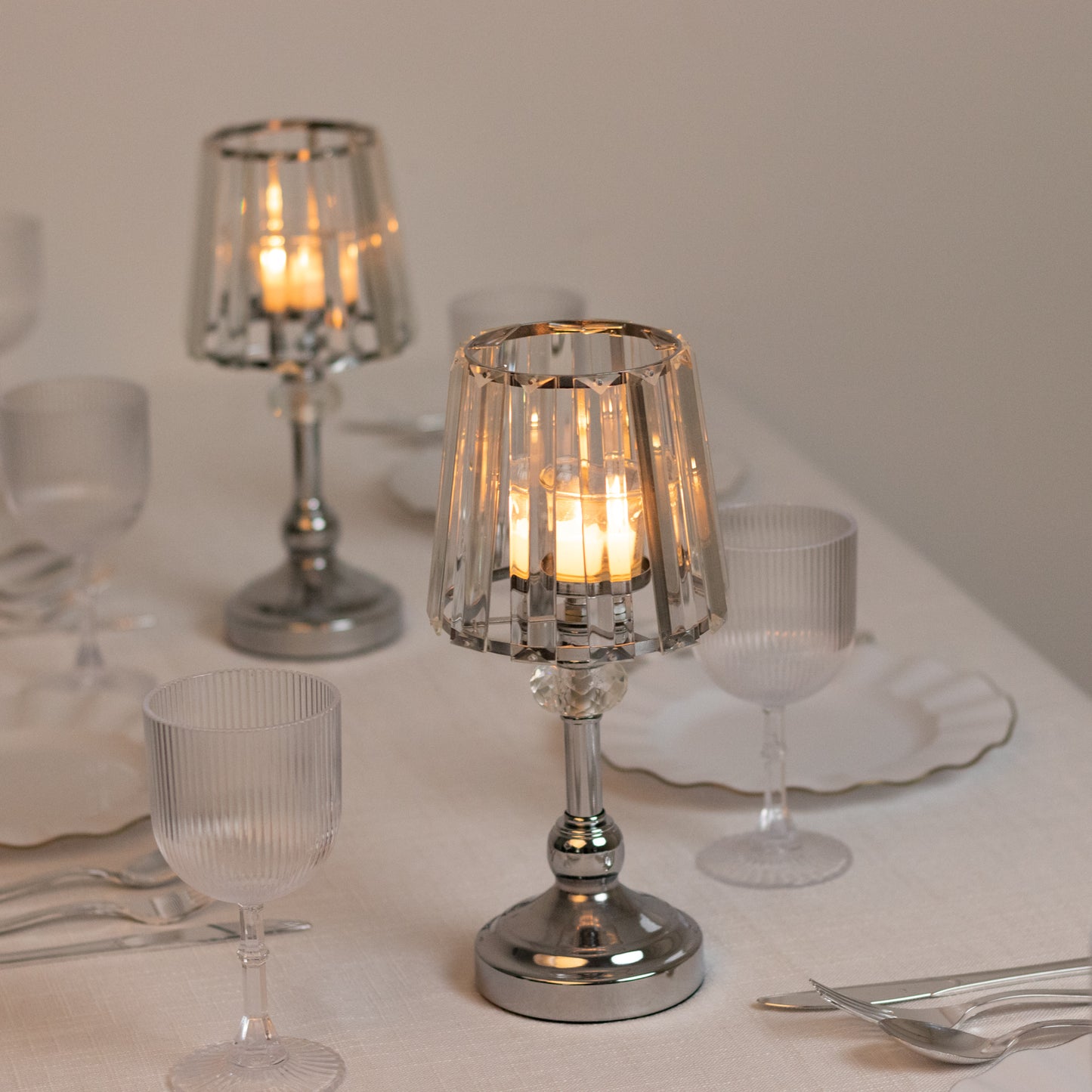 Silver crystal pendant candle holders on a table centerpiece.