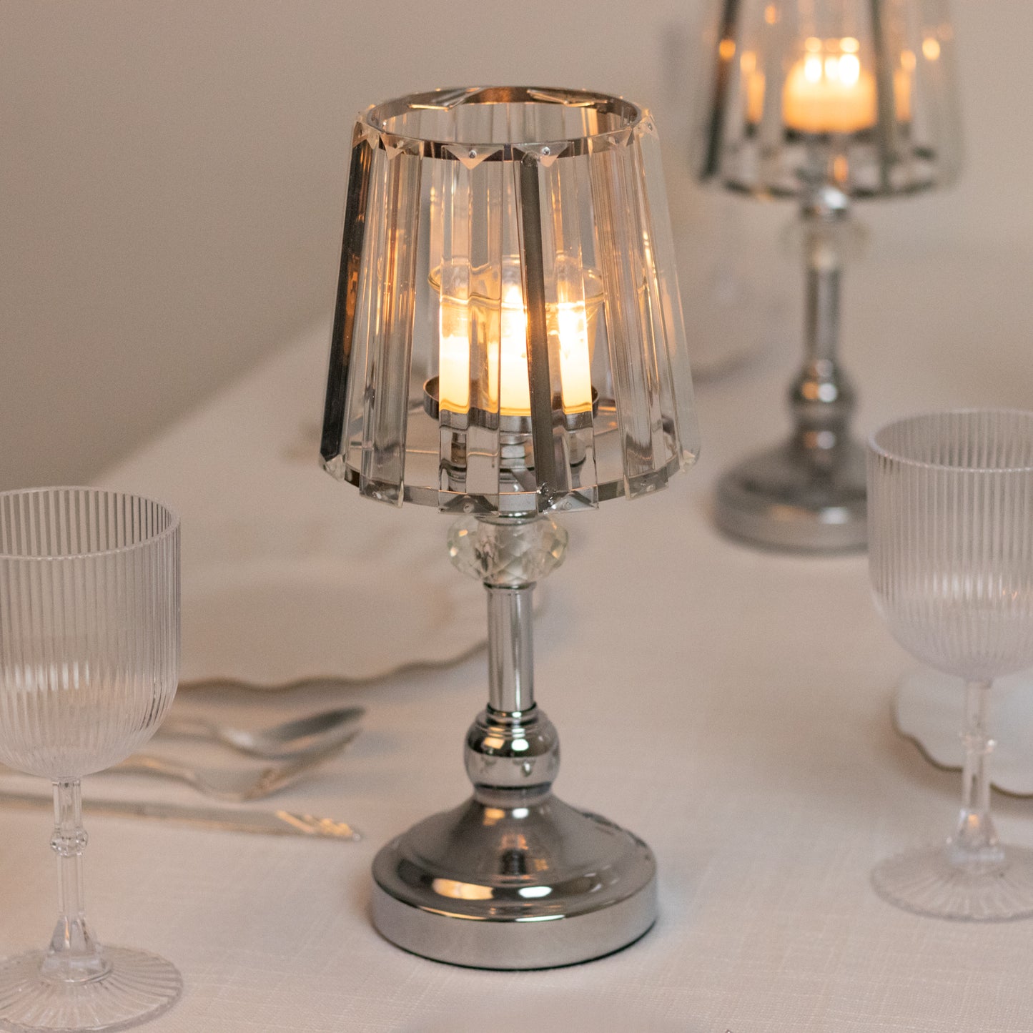 Silver crystal pendant candle holders for elegant table centerpieces.
