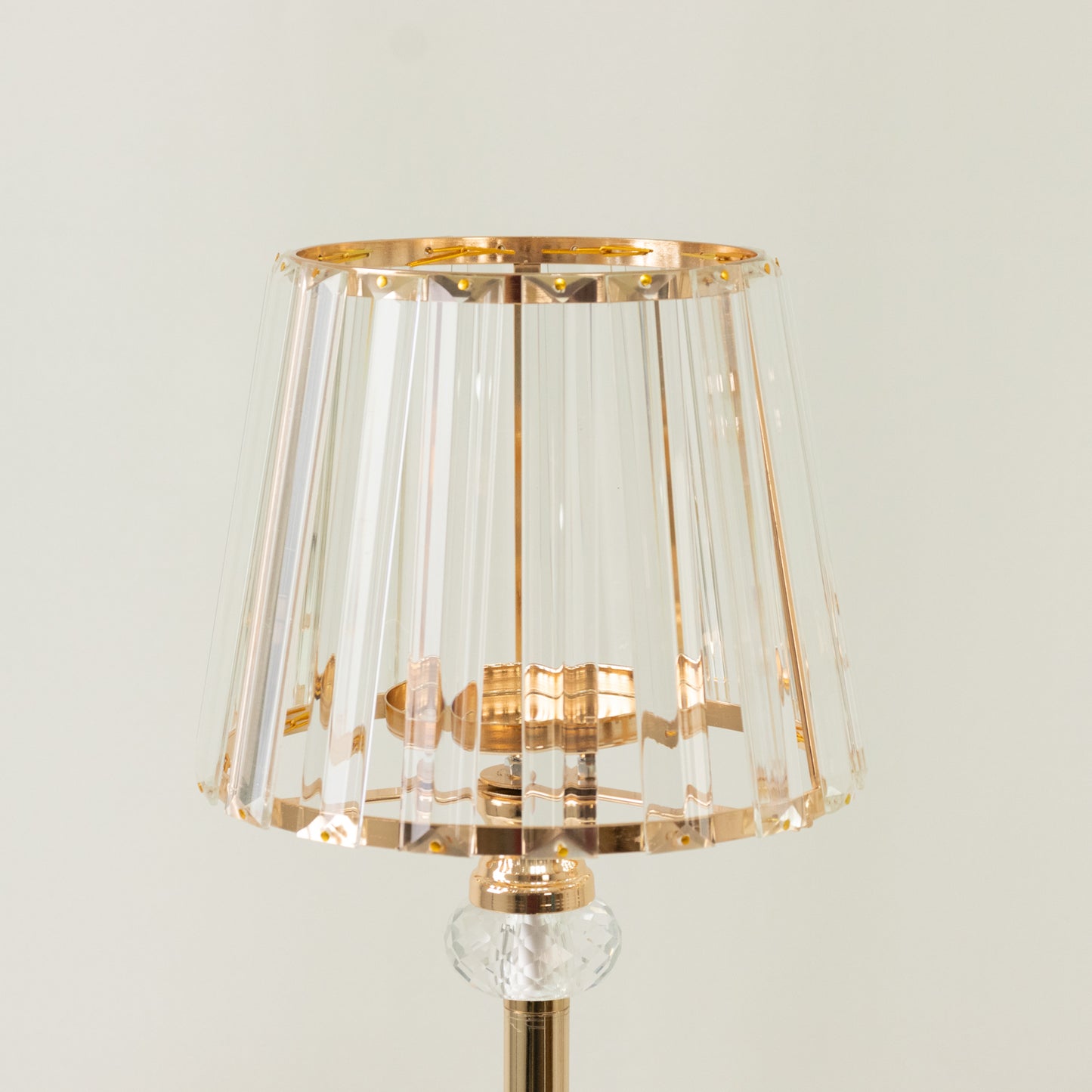 Gold crystal pendant candle holder with classic lamp shade design.