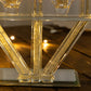 Crystal glass candelabra with crystal filler on a mirrored base.