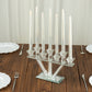 Clear crystal candelabra with 7 branches and taper candle holders on a wooden table.