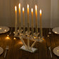 Clear crystal candelabra with seven taper candle holders on a mirrored base.