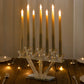 Crystal glass candelabra with seven taper candles on a rectangular mirror base.