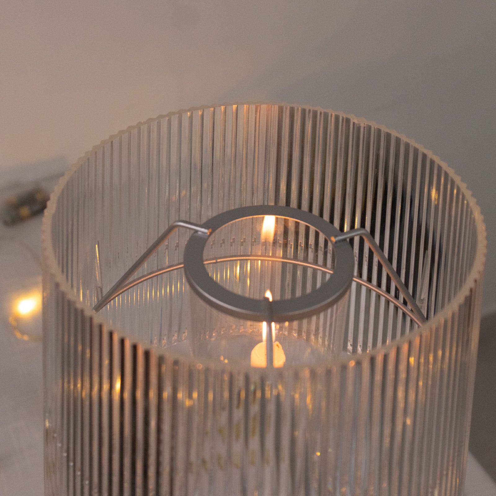 Clear acrylic candle lamp with ribbed shade for tealight and taper candles.