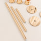 Set of 3 tall gold metal candlestick holders with glass shades.
