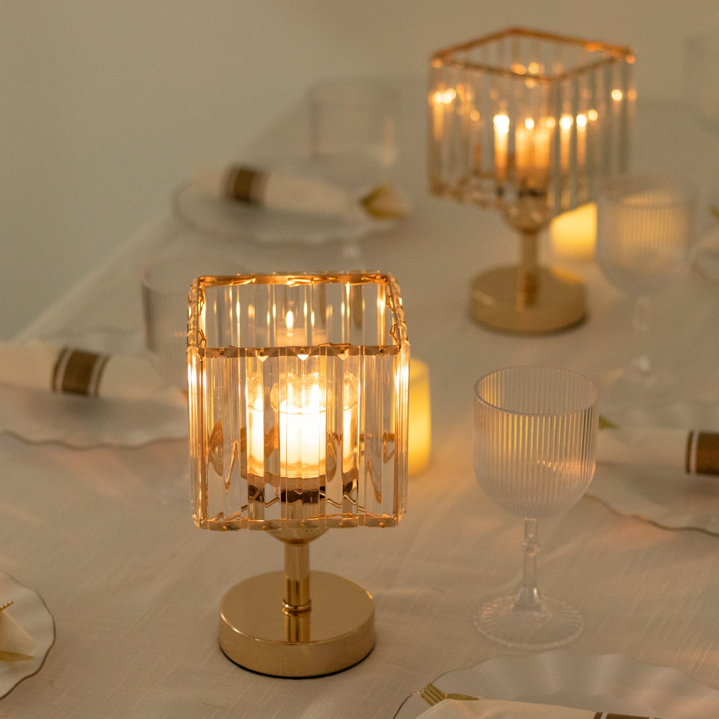 Gold crystal pendant candle holders for elegant table centerpieces.