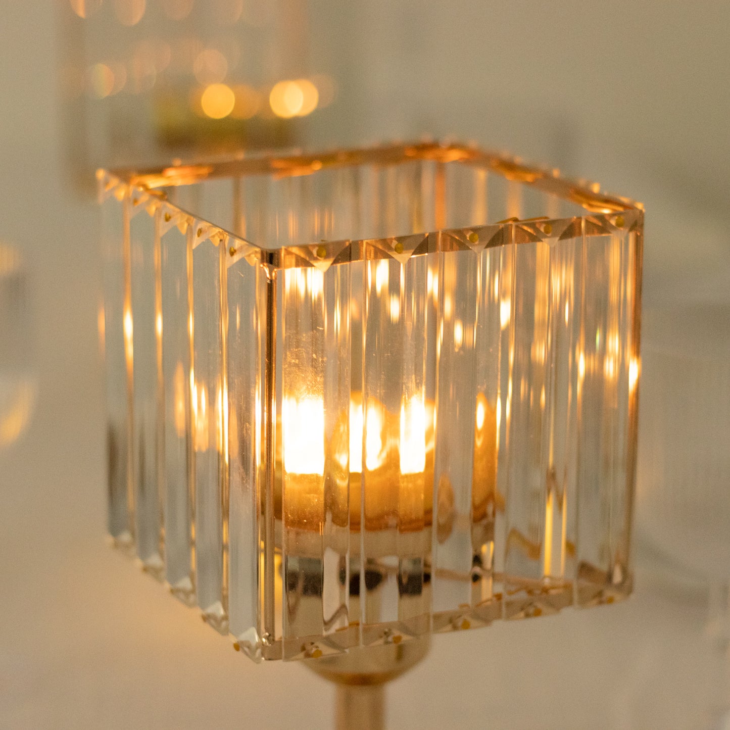 Gold crystal hurricane candle holder with elegant square design.