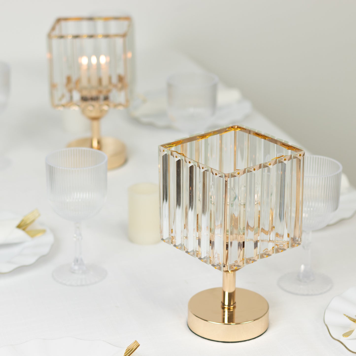 Gold crystal pendant hurricane candle holders for elegant table centerpieces.