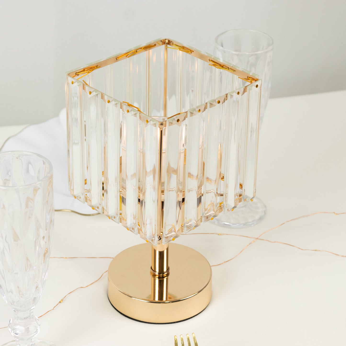 Gold crystal hurricane candle holder with elegant square design.