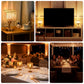Elegant gold hurricane candle holders for decorative table centerpieces.