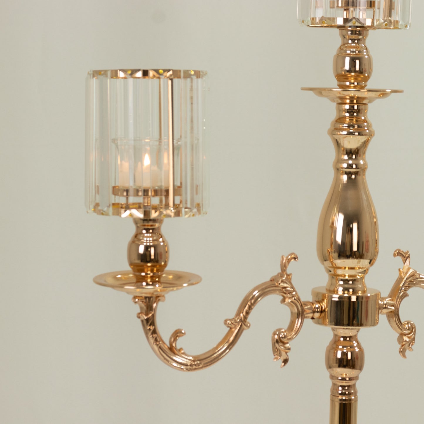 Gold 3-arm candelabra with crystal shades for pillar candles.