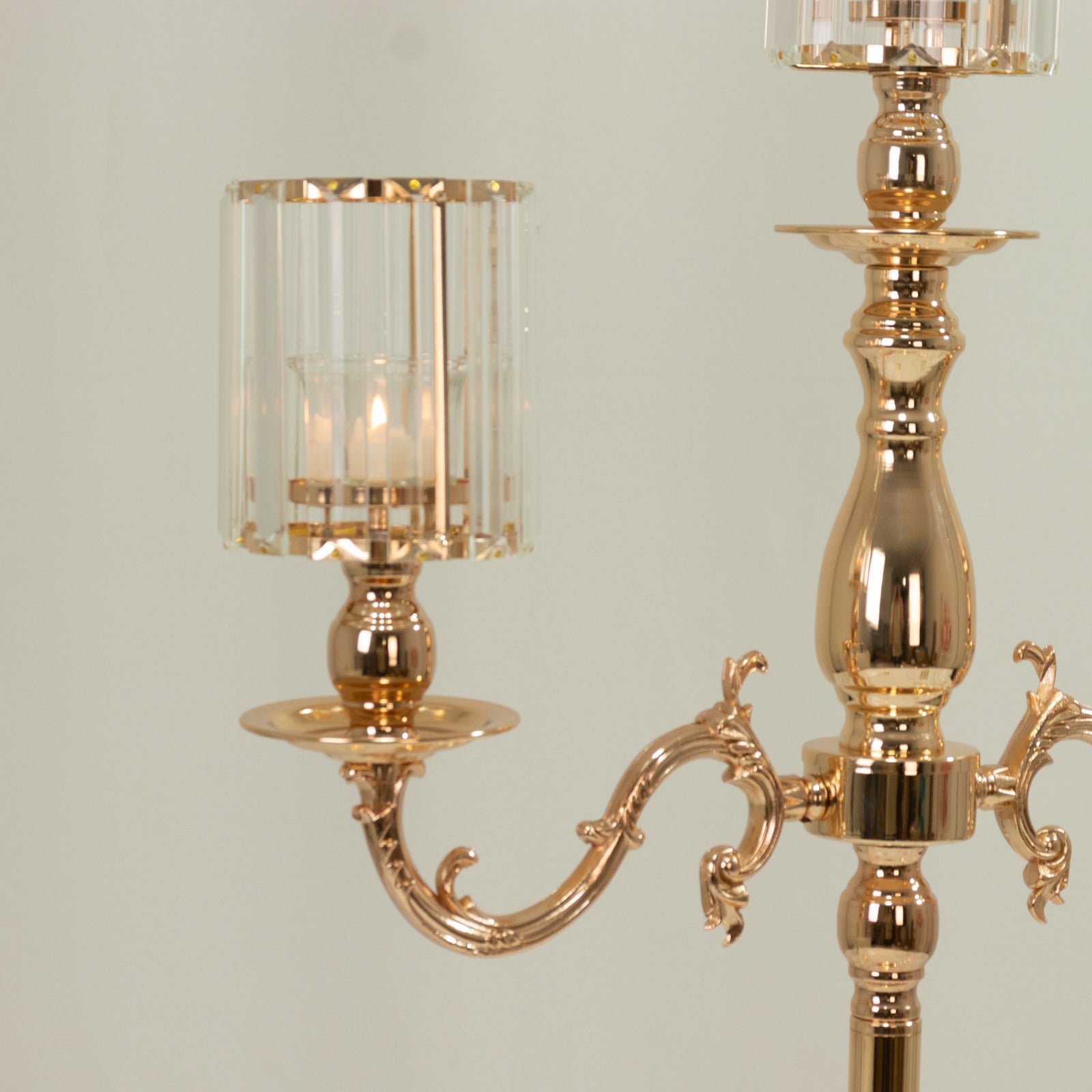 Gold 3-arm candelabra with crystal shades for pillar candles.