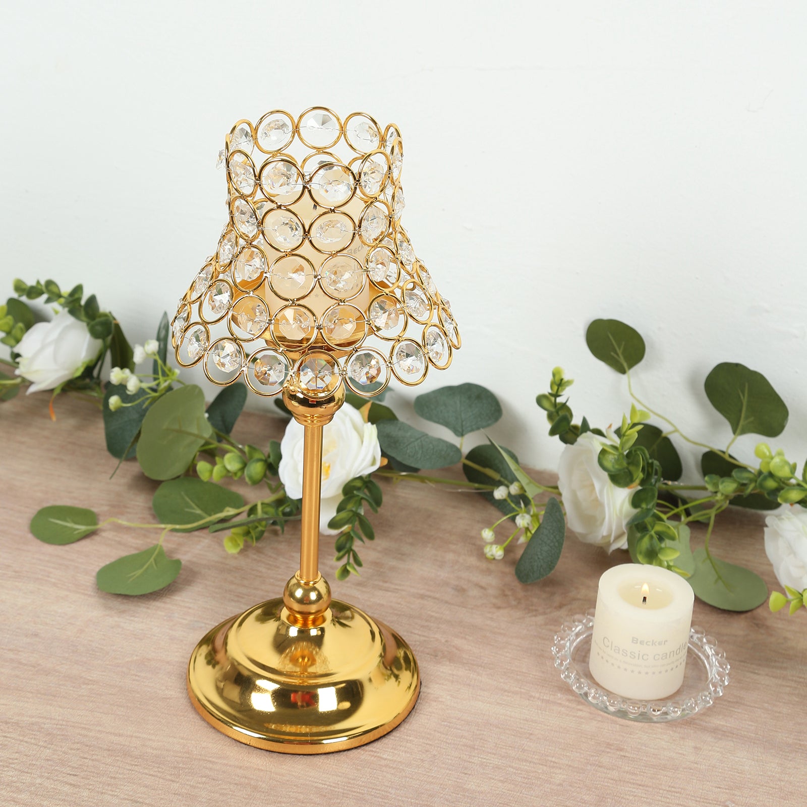 Gold crystal beaded candle holder with lamp-inspired shade for decor.