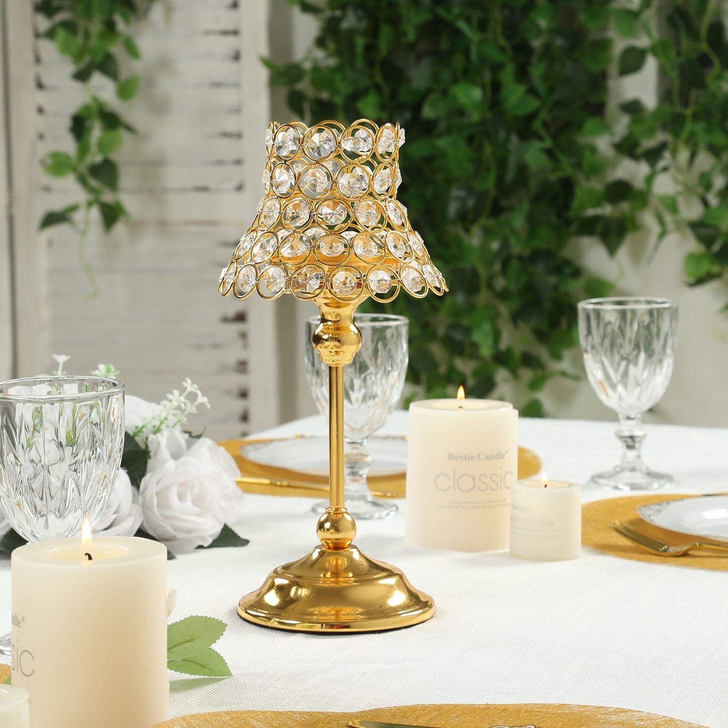 Gold crystal beaded candle holder with lamp-inspired shade for elegant table decor.